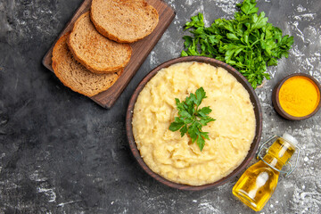 top view mashed potatoes bread slices on cutting board parsley turmeric oil on dark background