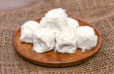 Turkish traditional dessert - Cotton Candy (Pismaniye on Turkish) on wooden plate. 