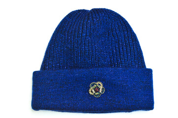 beautiful knitted woman hat with brooch decor, stylish and fashionable warm female winter clothing,...