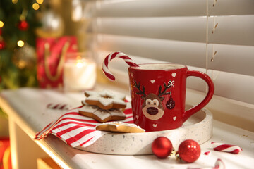 Composition with cup of hot drink on windowsill