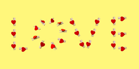 Love letters from clothespins on yellow background 