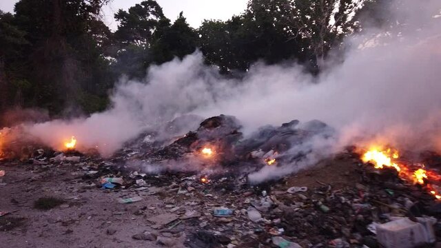Waste being burned on a remote island in india in the andaman sea because waste removal of tourist hotel waste is currently unfunded by the indian government