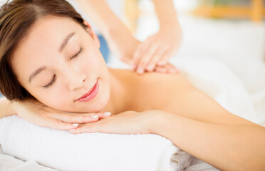 Fototapeta na wymiar relaxed Young woman enjoy massage in spa salon