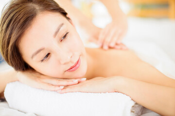 Obraz na płótnie Canvas relaxed Young woman enjoy massage in spa salon