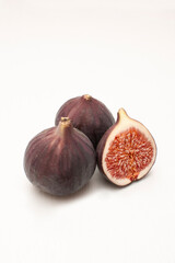 Fresh purple organic fig fruit isolated on white background. Healthy nutrition during diet. Fruits for vegetarians and vegans.