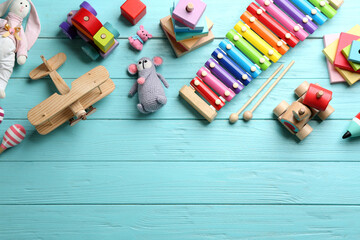 Different toys on light blue wooden background, flat lay. Space for text