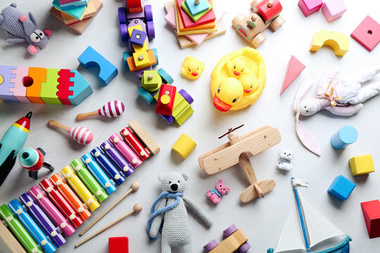 Different toys on light background, flat lay