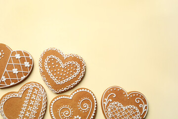 Tasty heart shaped gingerbread cookies on yellow background, flat lay. Space for text