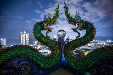 Fototapeta premium Wat Khao Phra Kru,Landmark of sriracha city with two of great Nagas guarded entrance to the view point and the crystal ball that gives an inverted view of the Sriracha scenery,Chonburi,Thailand