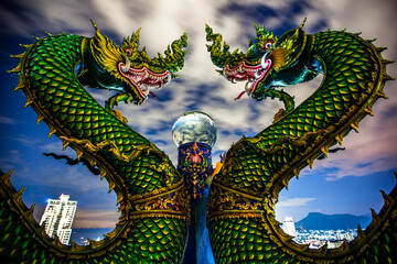 Fototapeta na wymiar Wat Khao Phra Kru,Landmark of sriracha city with two of great Nagas guarded entrance to the view point and the crystal ball that gives an inverted view of the Sriracha scenery,Chonburi,Thailand