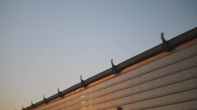 A truck loaded with grain emits smoke as it begins moving