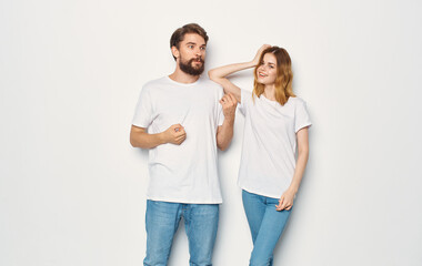 Couple in love man and woman light background fun emotions the same clothes