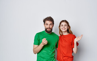 cheerful man and woman multicolored t-shirts embrace friendship emotions lifestyle