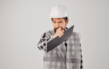Male builder documents engineer work gray background
