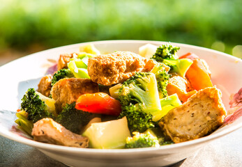 Fried tofu with broccoli and bell pepper in plate, in door  Chiangmai  Thailand