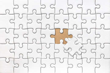 White blank jigsaw puzzle with last piece solve pattern texture for graphics design template.