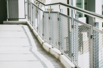 Sidewalks footpath with metal fences and stainless steel handles for safety walk in modern urban style.
