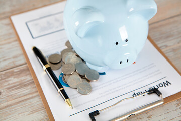 Piggy bank and coins on documents