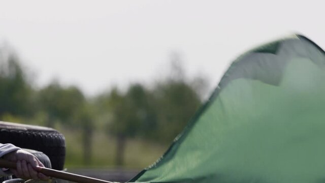 Green flag at a racetrack waving in slowmo.
