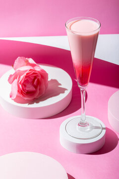 Pink cocktail on a pink background. Minimalistic set design