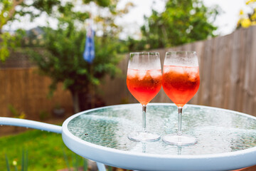 fruit spritz cocktails on cafe table setting in backyard
