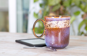 A cup of tea and e-book reader