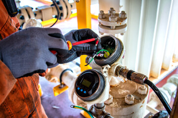 Hand of technician,Instrument technician on the job calibrate or function check level transmitter...