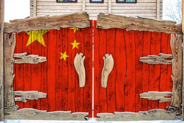 Close-up of the national flag of China. on a wooden gate at the entrance to the closed territory. The concept of storage of goods, entry to a closed area.