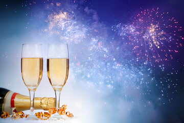 Two glasses of champagne in new year fireworks