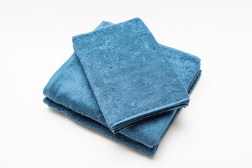 白背景に置いて撮影した青いバスタオルとフェイスタオル