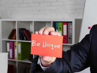 Business concept meaning  Be Unique    with phrase on the page.