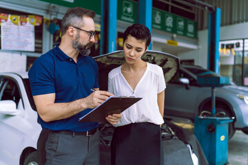 The mechanic talking with customer female