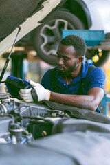 African-American mechanic working in car service center