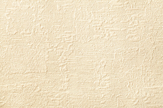 Texture of beige wallpaper with relief and godler pattern. Paper background.