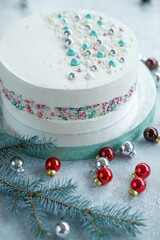 Vanilla sponge cake with cream and white chocolate decorate. Sliced piece of cake on white plate....