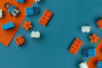 constructor lies on an orange-blue background, top view, photo with empty space