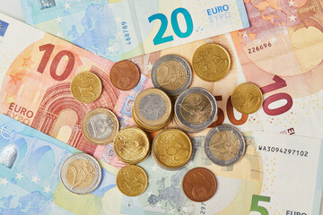 Money background. 20, 10 and 5 Euros in paper money and various coins euro cents macro close up 