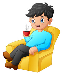 A man sitting on the sofa while holding a cup of hot coffee