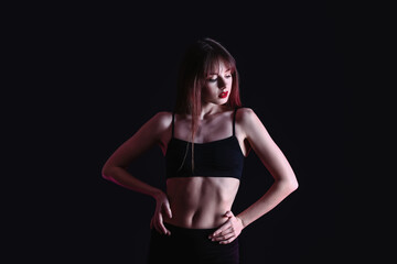 Fototapeta na wymiar Beautiful young woman in underwear on dark background