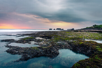 abstract long exposure photography of sea beach rock landscape seascape during epic sunset, calm tranquil meditative quiet