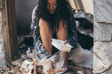 poor people,homeless or beggar begging for help sitting at dirty slum.concept for poverty...