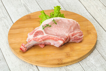 Raw pork bone steak over wooden