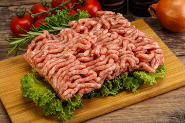 Raw pork minced meat over board