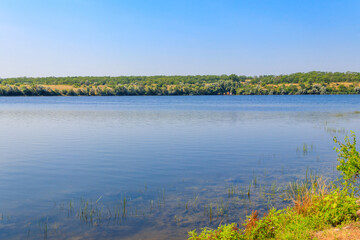 Summer landscape with beautiful river, green trees and blue sky
