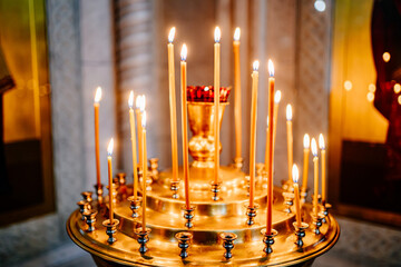 a candle holder with many candles in the Church.