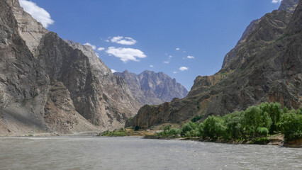 Naklejka na ściany i meble Beautiful panoramic landscape view along the Pamir Highway of the Panj river valley between Afghanistan and Tajikistan in Vanch district, Gorno-Badakshan, Tajikistan