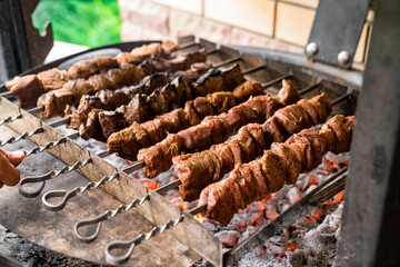 shish kebab is cooked on skewers on coals. barbecue in the yard.