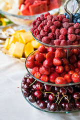 plate with summer berries-raspberries, strawberries, blueberries, sweet cherry.
