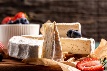 Fresh strawberries and brie cheese wooden board. banner menu recipe place for text