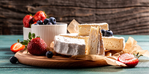 Fresh strawberries and brie cheese wooden board. banner menu recipe place for text